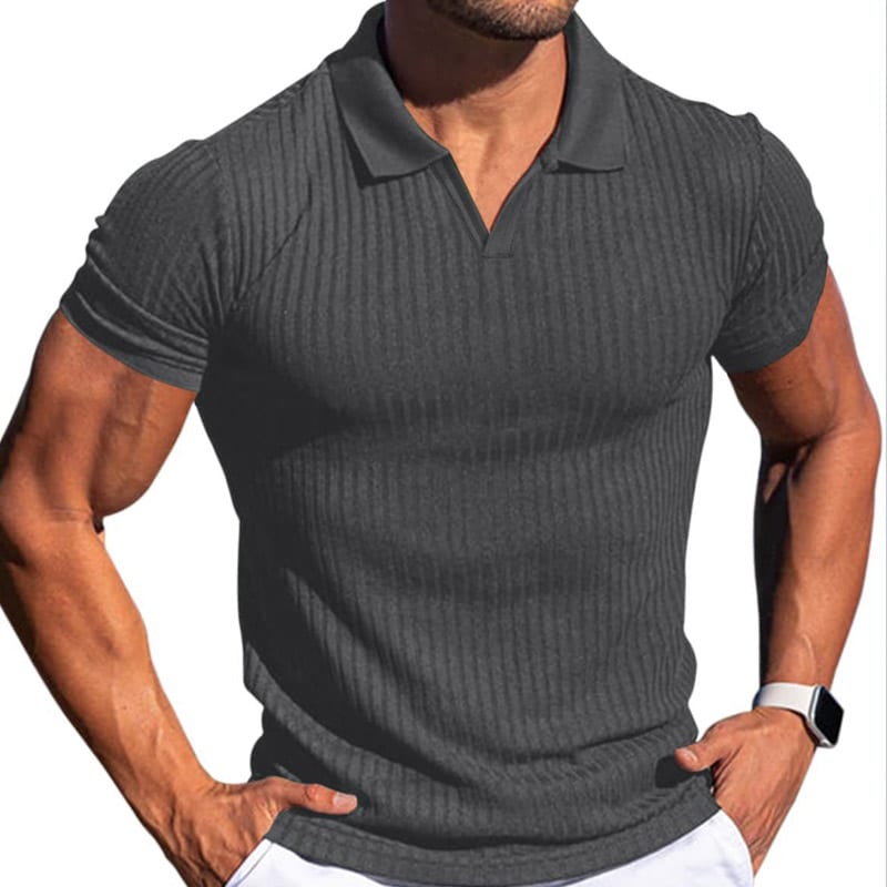 Male model fitted dark grey advanced spandex interlock polo shirt, full vertical rib seamless knit, notch v-neck polo collar, raglan short sleeves, 4-way stretch compression performance fabric for gym & smart casual wear.