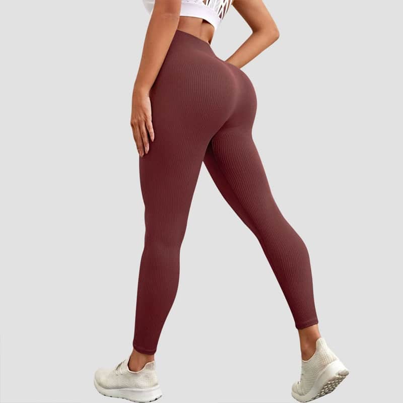 Rear shot of burgundy vertical rib seamless leggings made from recycled polyester blend sustainable knit fabric, high rise non-slip waistband.
