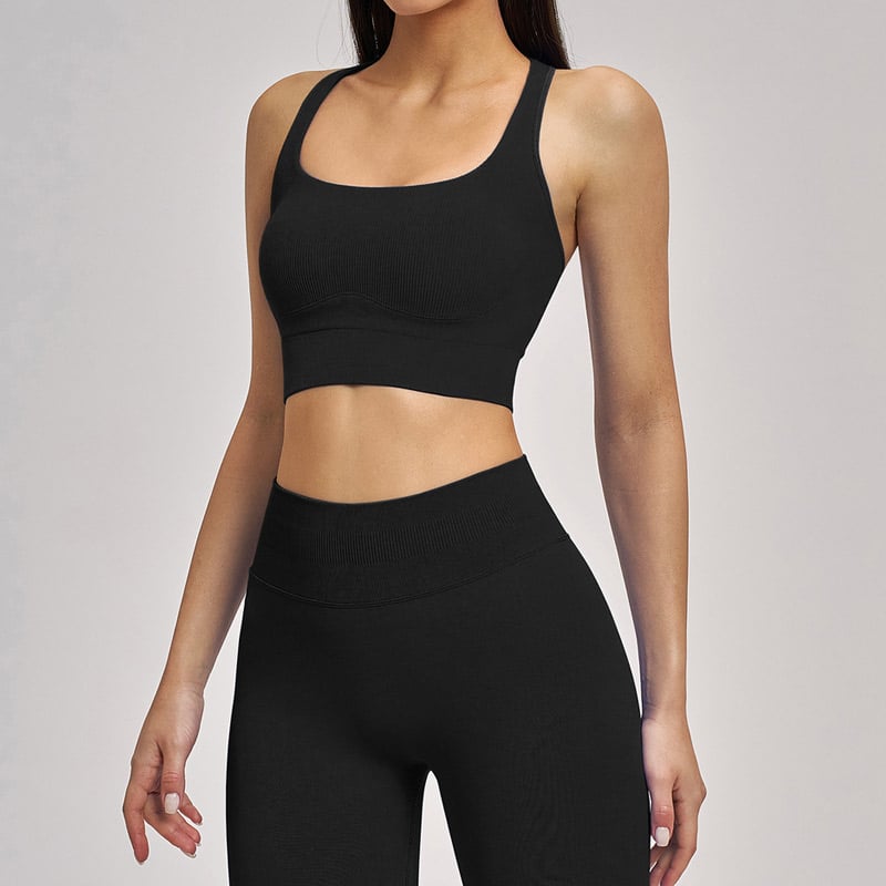 Front studio shot of womenโs solid black ribbed seamless workout set, wide square neck racerback ribbed sports crop bra, matching high rib compression waist full-length seamless leggings, vertical rib nylon spandex stretch knit, breathable squat-proof fabric for yoga, gym training and daily athleisure, OEM custom seamless leggings & activewear sets wholesale factory.