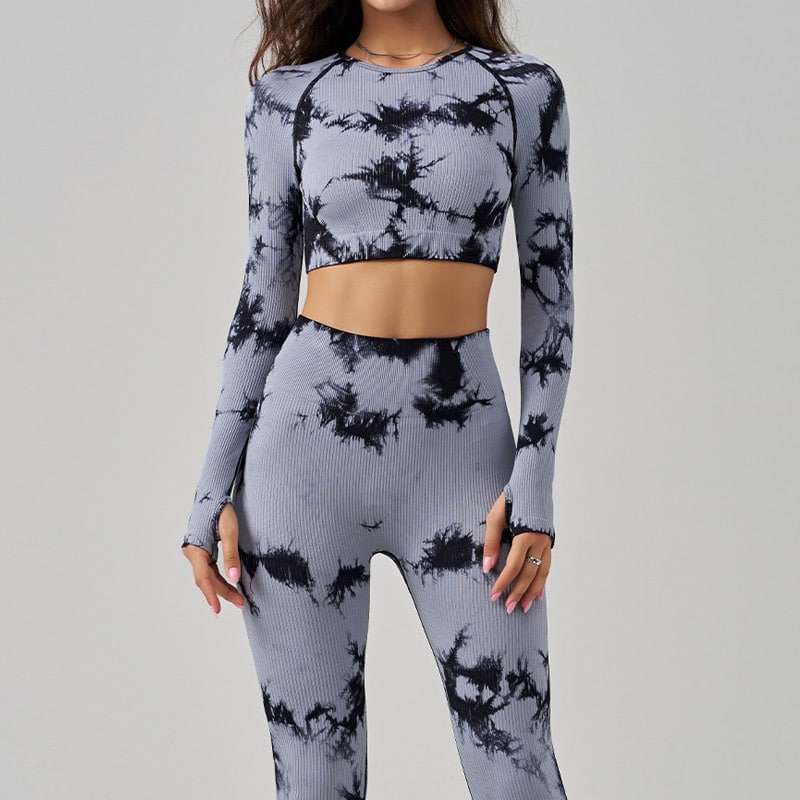 Womenโs grey black tie-dye seamless leggings and long-sleeve crop top set, ribbed stretch knit, high-waisted compression leggings, thumb-hole sleeves, moisture-wick activewear for yoga, gym and casual athleisure, OEM custom seamless activewear manufacturer.