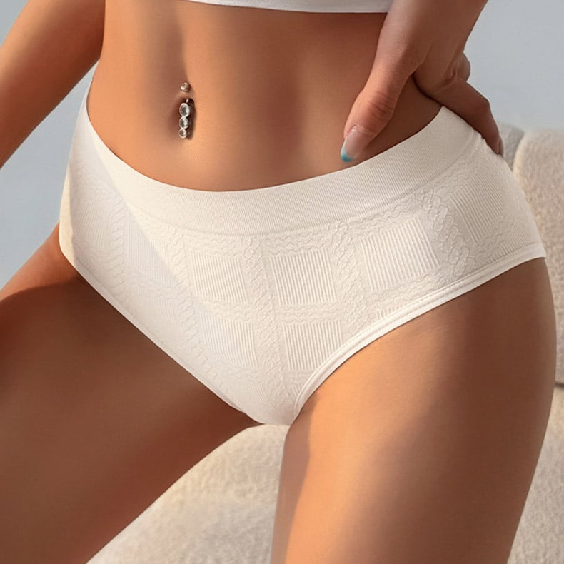 Warm studio close-up shot of womenโs off-white precision seamless boxer briefs, intricate square cable jacquard textured knit, wide smooth rib non-slip waistband, ultra-soft breathable stretch fabric, precision CNC circular knit construction, tag-free anti-chafe fit for daily & active intimates, OEM custom underwear supply.